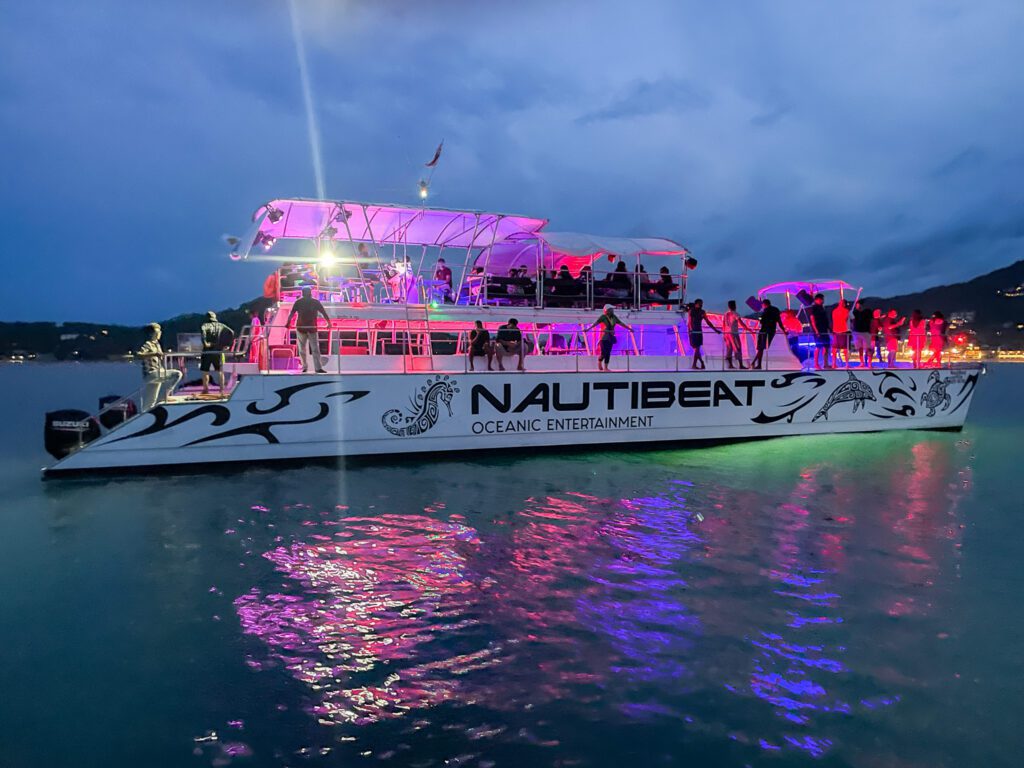 Party boat outside Koh Samui illuminated by bright lights