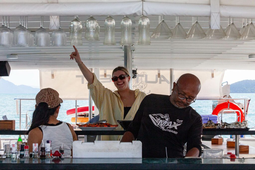 Smiling people at a bar on a boat